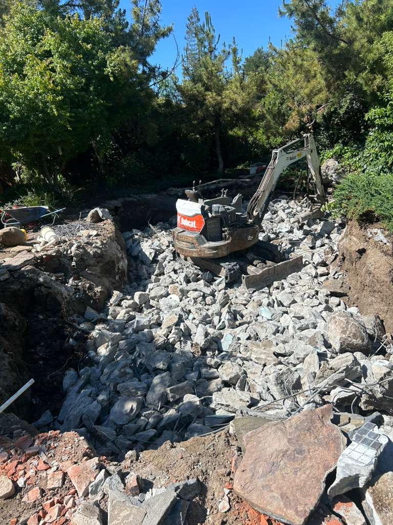 Bobcat Excavator Breaking Pool Concrete